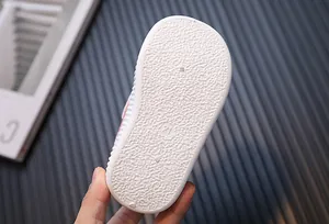 Close-up detail showing the textured anti-slip white rubber sole of a toddler shoe size 21
