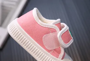 Detailed side view of pink toddler canvas shoe with Velcro strap for toddlers