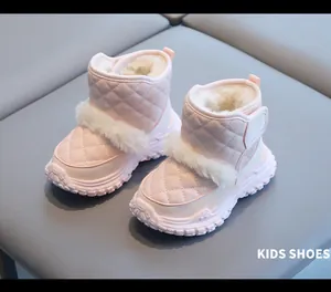 Close-up of pink quilted toddler snow boots with soft white faux fur lining