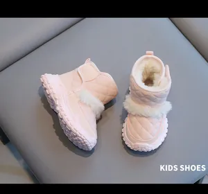Detail view of pink kids snow boots with warm white fleece lining and non-slip sole