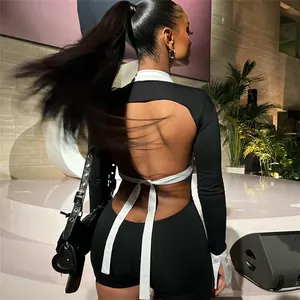 Detail view of sexy backless long sleeve jumpsuit with black and white color blocking