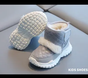 Close-up detail of grey kids snow boots featuring warm plush lining and white non-slip sole