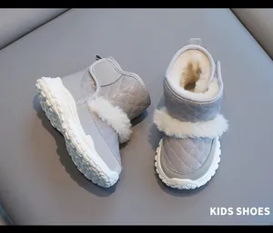 Close-up detail of grey children's winter snow boots featuring warm white faux fur lining