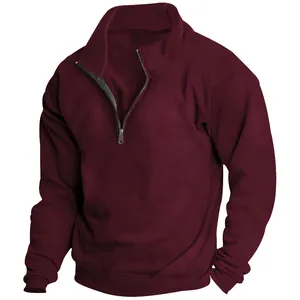 Close-up detail of men's burgundy fleece sweatshirt with a half-zip stand collar