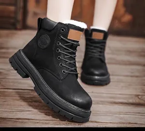 Detailed view of black British style Martin boots featuring warm white fuzzy lining