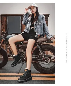 Detail view of black lace-up Martin boots worn by a model in a street style setting