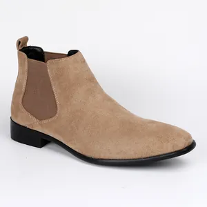Detail view of men's tan suede Chelsea boots featuring black elastic side panels