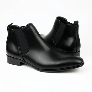Detailed view of polished black men's Chelsea boots with classic elastic side panel