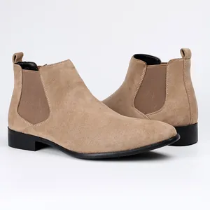 Detailed side view of tan suede Chelsea boots with square toe and elastic panels