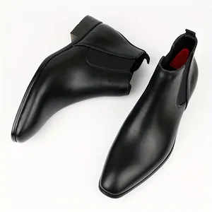 Top view of elegant classic black leather men's Chelsea boots with elastic side panels