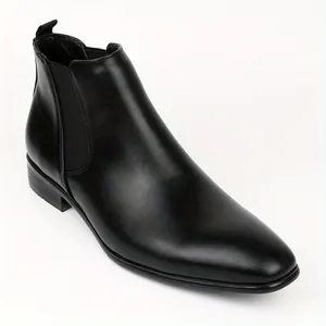 Close-up of black leather Chelsea boots showing smooth texture and elastic side panels