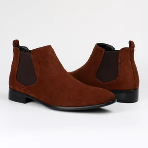 Detailed macro view of brown suede texture and square toe design on men's Chelsea boots.