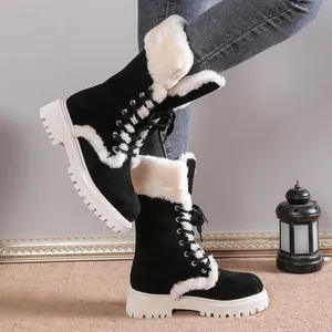 Stylish black suede snow boots with white faux fur trim and platform soles