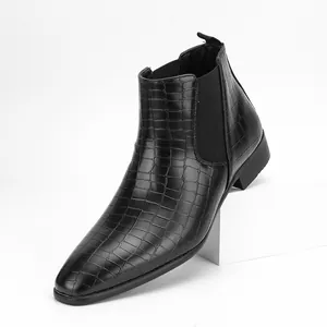 Side detail of men's black crocodile embossed leather Chelsea boots with pointed toe