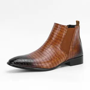 Side profile of brown men's Chelsea boots featuring a textured crocodile pattern