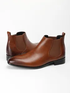 Detailed side view of men's brown Chelsea boots with square toe and elastic panel