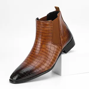 Detailed side view of a brown men's Chelsea boot featuring a crocodile skin pattern