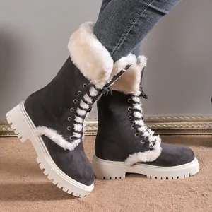 Warm grey suede snow boots with thick white lug soles and white fur lining.