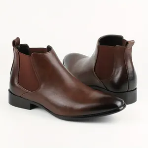 Detailed side view of stylish men's brown Chelsea boots with square toe and elastic panel