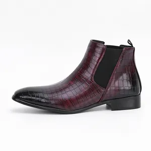 Side view of burgundy crocodile textured men's Chelsea boot with black elastic side