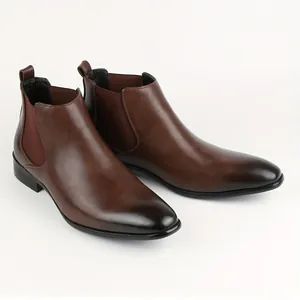 Detailed side view of brown men's Chelsea boots with a stylish square toe design.