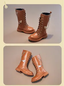 Modische hohe Mädchenstiefel aus Leder mit Herzanhänger und Schnürung im Detail