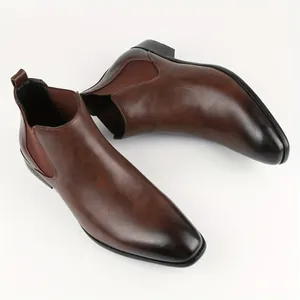 Detail of brown leather Chelsea boots with elegant square toe and polished finish