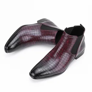 Detail view of men's burgundy crocodile embossed leather Chelsea boots with gradient toe