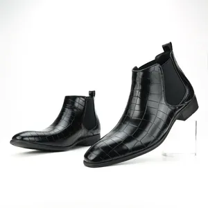 Detailed macro view of black crocodile embossed leather Chelsea boots with square toe for men