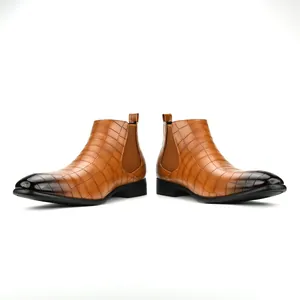 Detailed side view of tan crocodile-pattern Chelsea boots with burnished square toes.