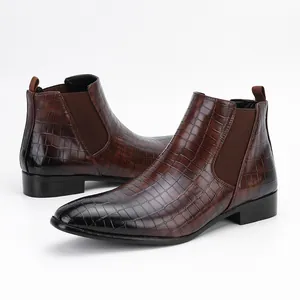 Side view of men's brown crocodile pattern Chelsea boots with elastic side panels