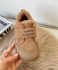 Close-up of children's winter suede shoe with warm faux fur lining and velcro strap