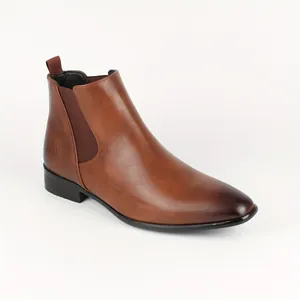 Side view of men's brown Chelsea boots with elastic side panels and burnished toe