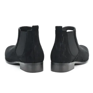 Detailed rear view of stylish black suede men's Chelsea boots with a modern square toe design