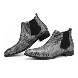 Detail view of silver fish-scale textured men's Chelsea boots with elastic panels