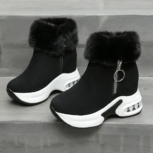 Nahaufnahme schwarzer Winterstiefel mit Kunstpelzkragen und dicken weißen Plateausohlen