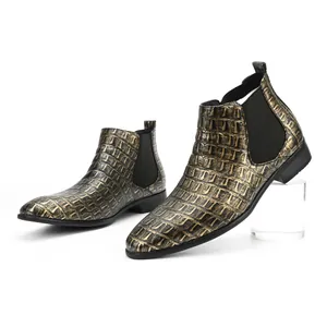 Macro view showing the metallic gold crocodile texture on men's square toe Chelsea boots