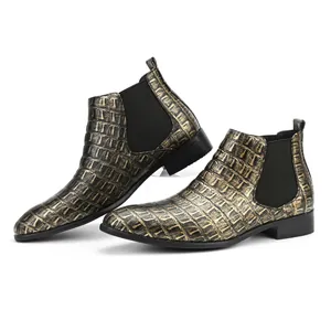 Close-up of men's square toe Chelsea boots with metallic crocodile embossed texture.