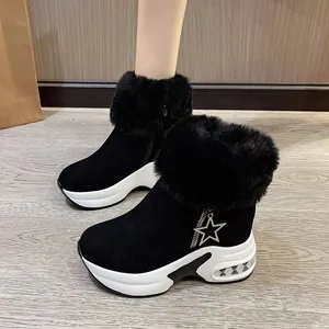 Detailansicht schwarzer Wildleder-Schneestiefel mit Kunstfellkragen und Stern-Anhänger