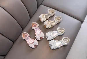 Draufsicht auf funkelnde Strass-Prinzessinnenschuhe für Mädchen mit Perlenriemen und Schleifen