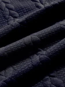 Close-up of heavy jacquard fabric texture on a navy men's American style sweatshirt