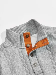 Macro view of men's grey jacquard sweatshirt showing stand-up collar and button placket