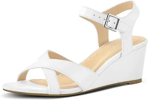 Detailed side view of white wedge sandal featuring cross straps and adjustable ankle buckle