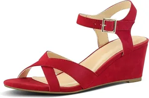 Elegant red suede wedge sandals with crossover straps and ankle buckle closure.
