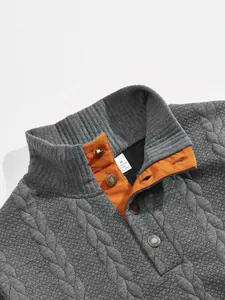 Close-up detail of a men's grey jacquard sweatshirt featuring a stand collar and buttons