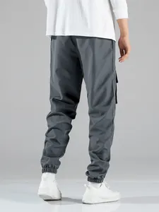 Back view of men's dark grey multi-pocket cargo jogger pants for high street casual wear