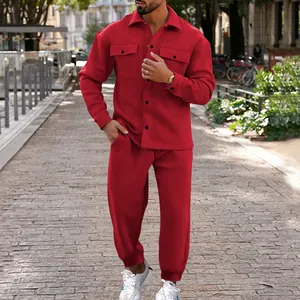 Detailed view of a men's burgundy suede tracksuit set being worn by a model outdoors