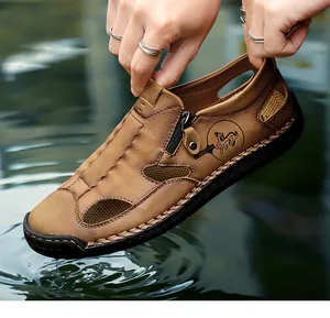 Close-up view of brown genuine leather men's loafers with hollow design above ripples