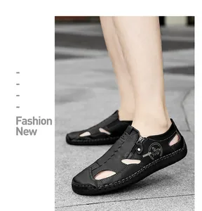 Detail of men's black leather casual loafers featuring breathable cutouts and side zipper