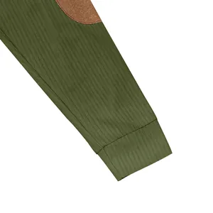 Close-up detail of olive green ribbed sweatshirt sleeve with a brown oval elbow patch